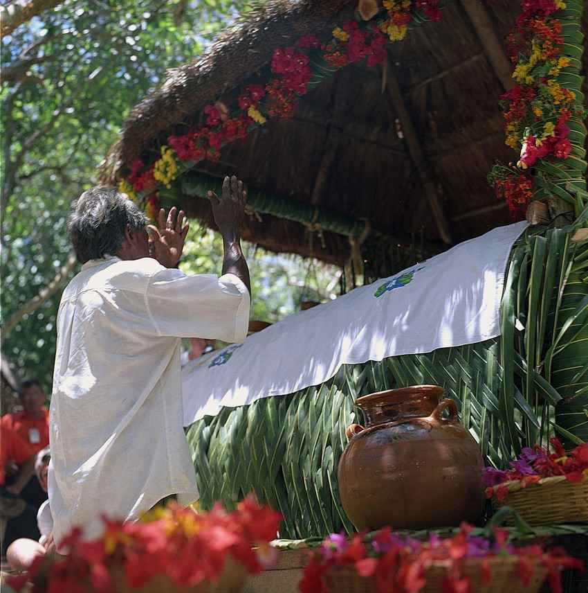 A man performing a Mayan ritual in the jungle.