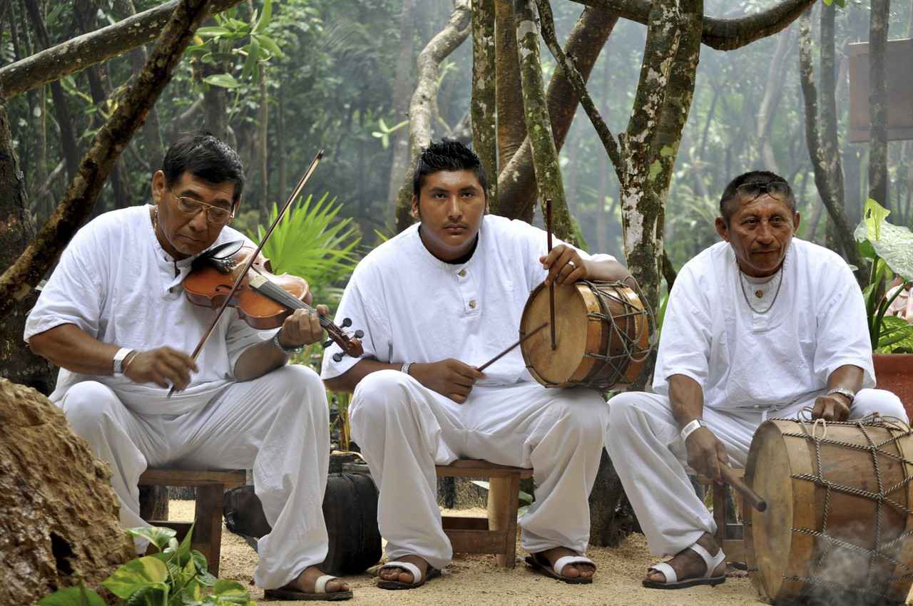 Three men playing Mayan music in the jungle.
