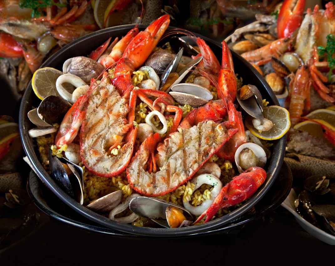 A pan full of cook seafood ready to be served to customers.