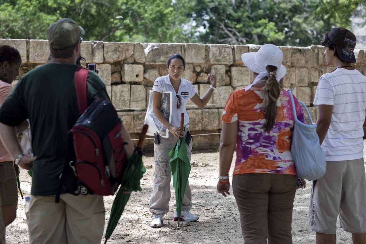 A Chichen Itza tour guide explaining the history of the Mayan ruins.