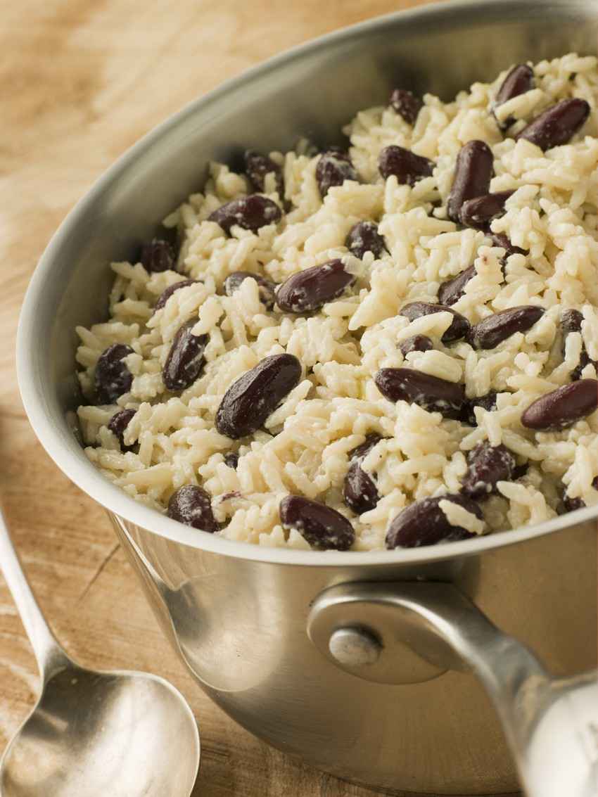 Delicious rice and beans cooking in a stainless steel pot.