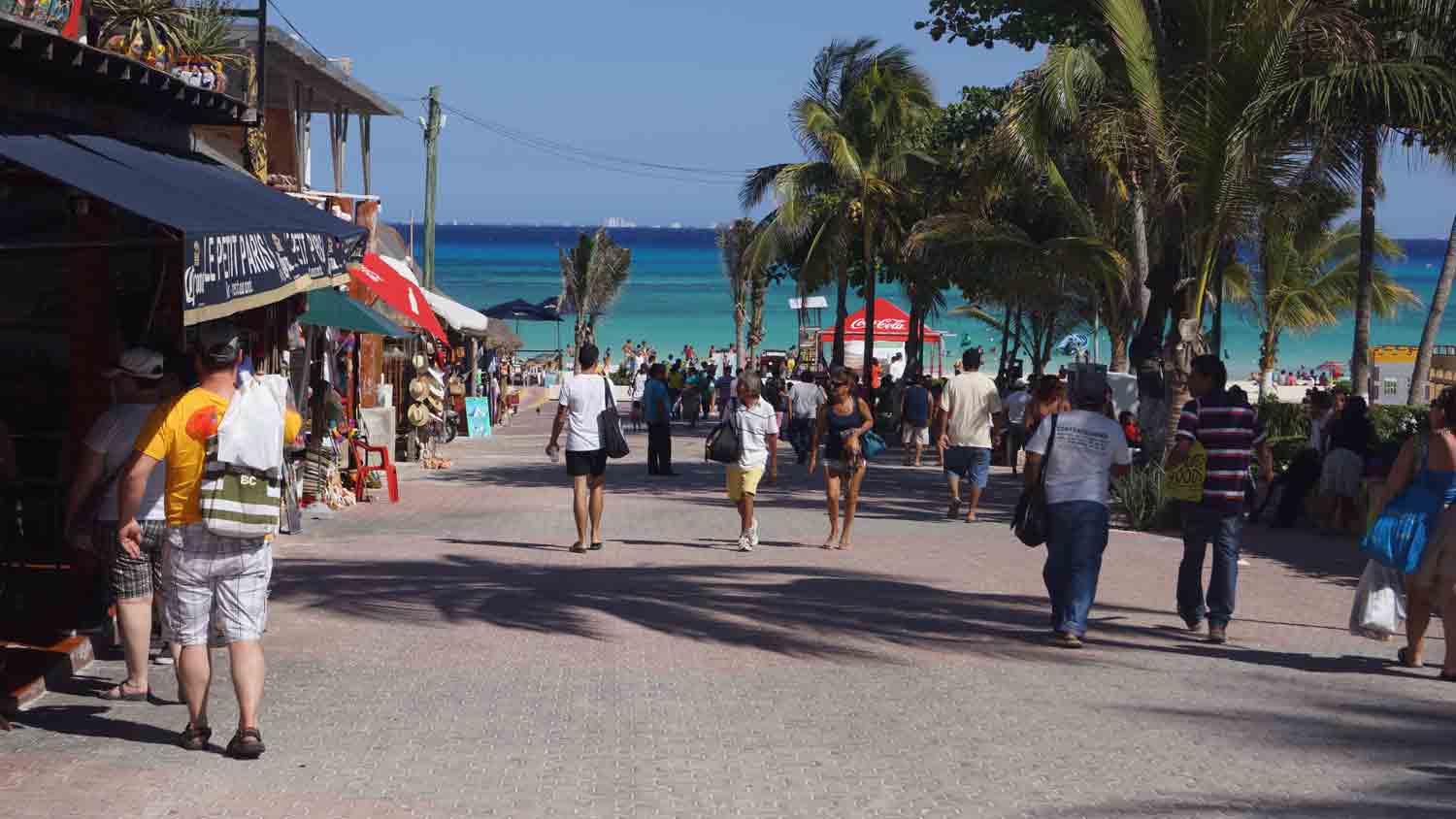 A central street that runs directly into the beach in Playa Del Carmen.