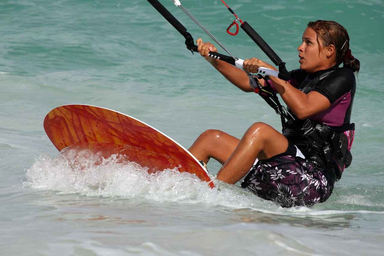 A gorgeous woman looking into the air while kite boarding near Playa Del Carmen.