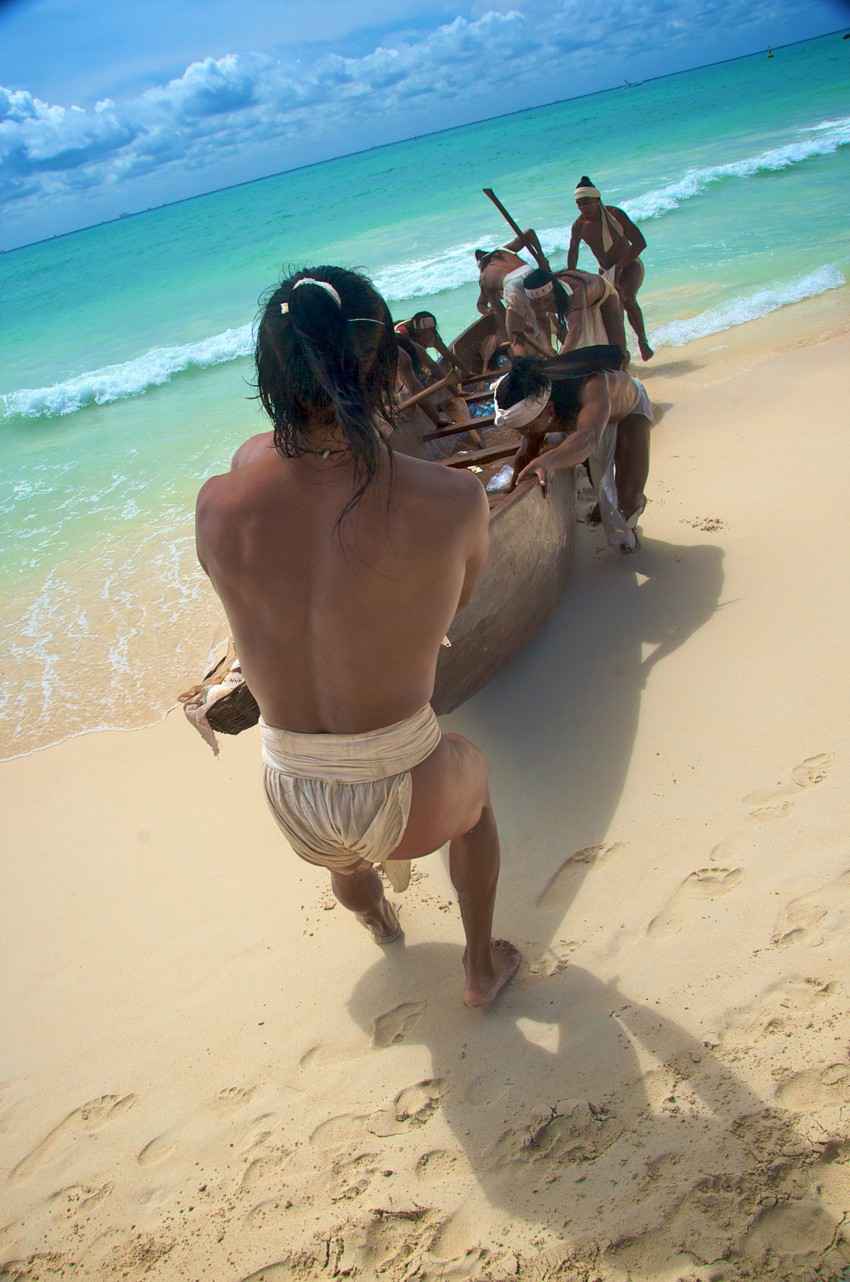 A group of several modern Mayan men practicing for the sacred journey that takes them from the Playa Del Carmen shoreline to Cozumel Island.