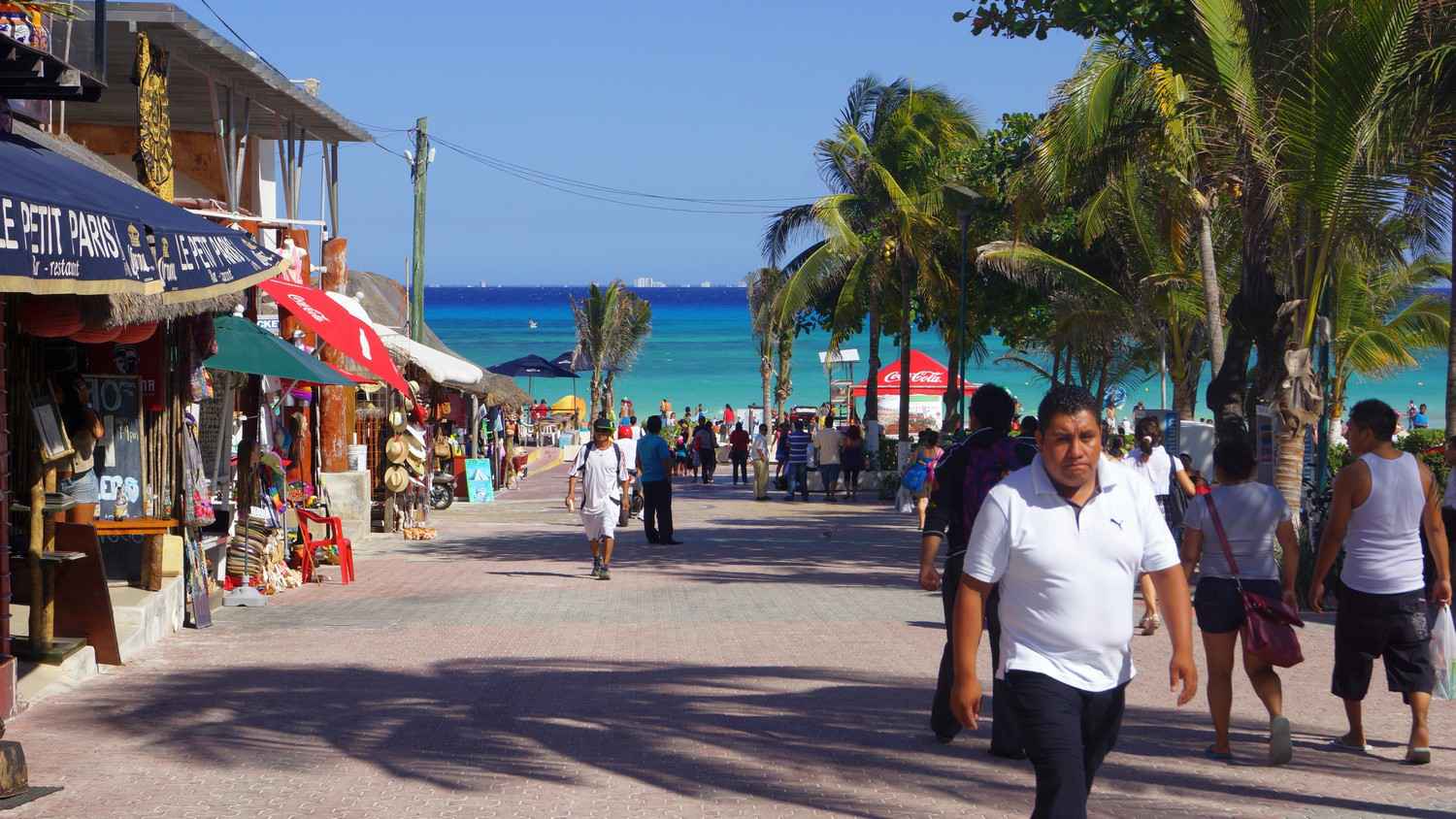 A view of the aqua blue water and beach with Cozumel visible in the background.