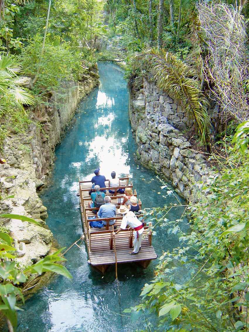 A group of tourists riding a boat down the river.
