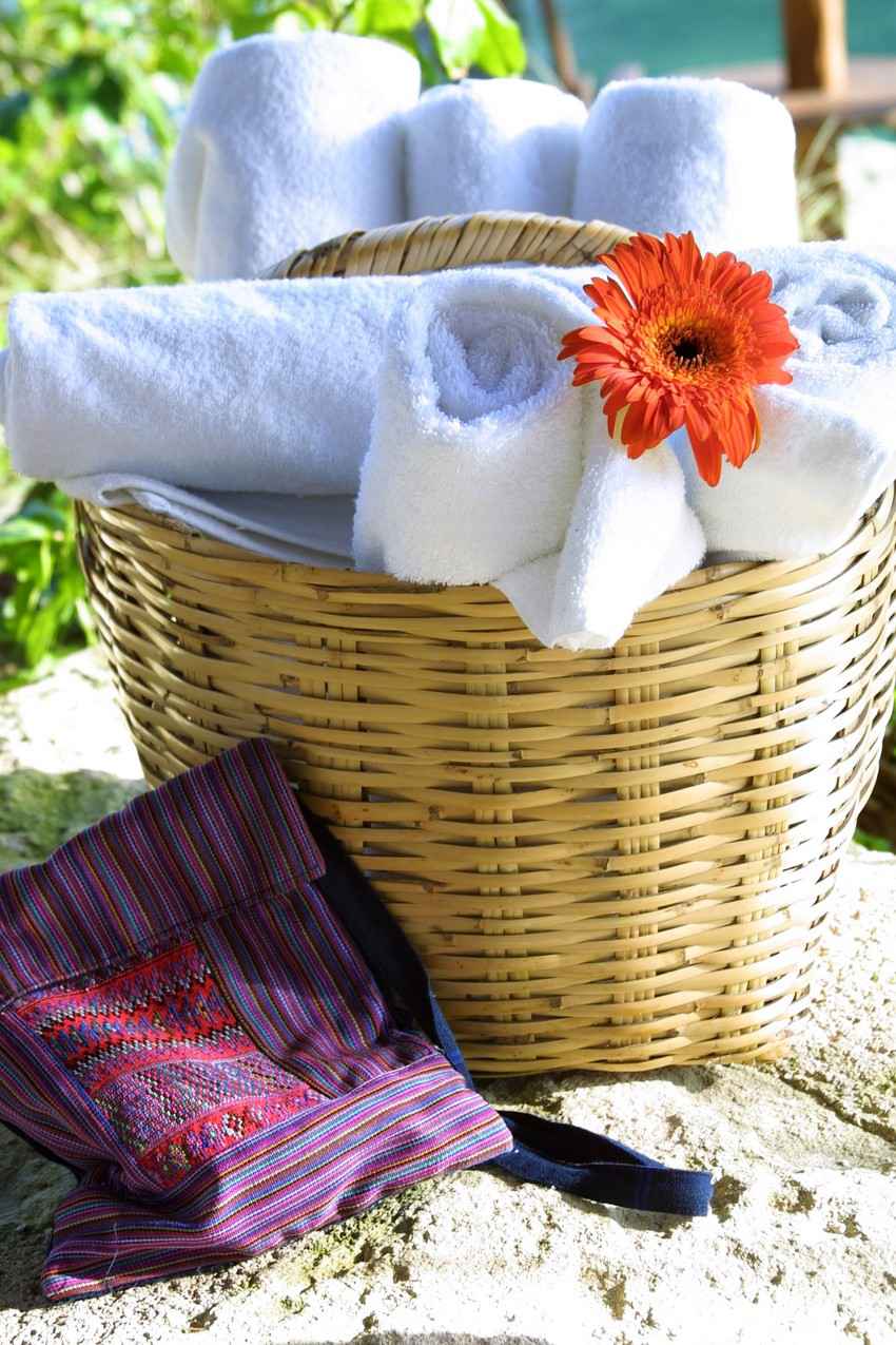 A basket with an abundance of towels for guests at a beach hotel in Playa Del Carmen.