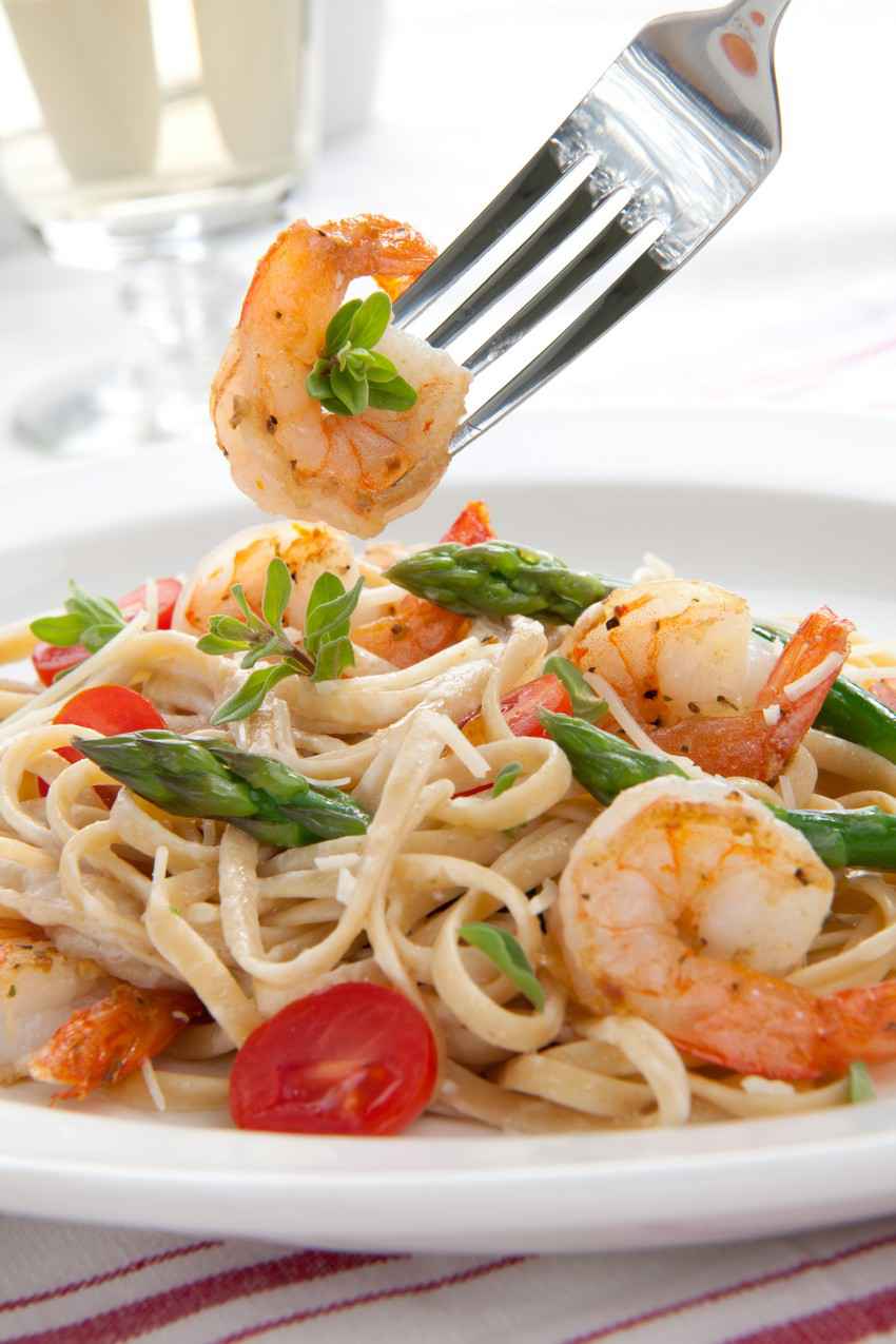 Shrimp fettuccine with asparagus and tomatoes.