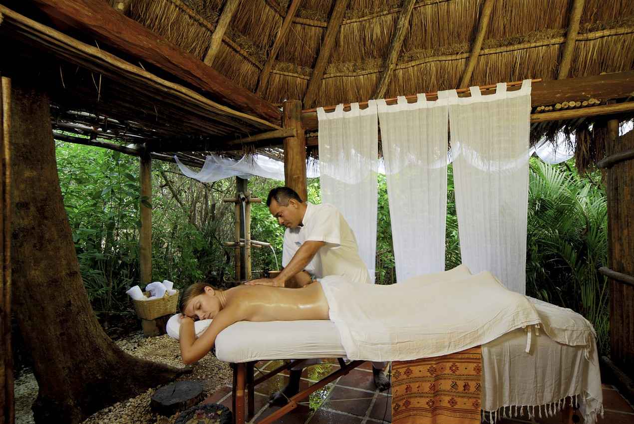 A woman receiving a natural rain forest-inspired massage near Playa Del Carmen.