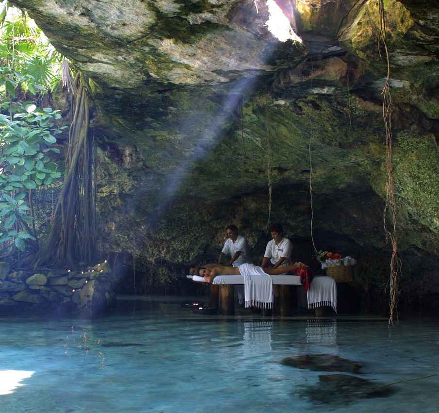 A woman receiving an exotic massage at the entrance of a local cenote.
