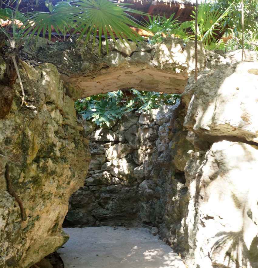 An amazing stone walkway under a palapa.