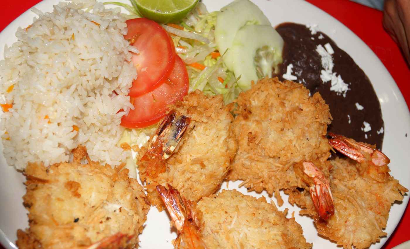 A plate of deep-fried shrimp with rice and vegetables as served at a restaurant in Playa Del Carmen.