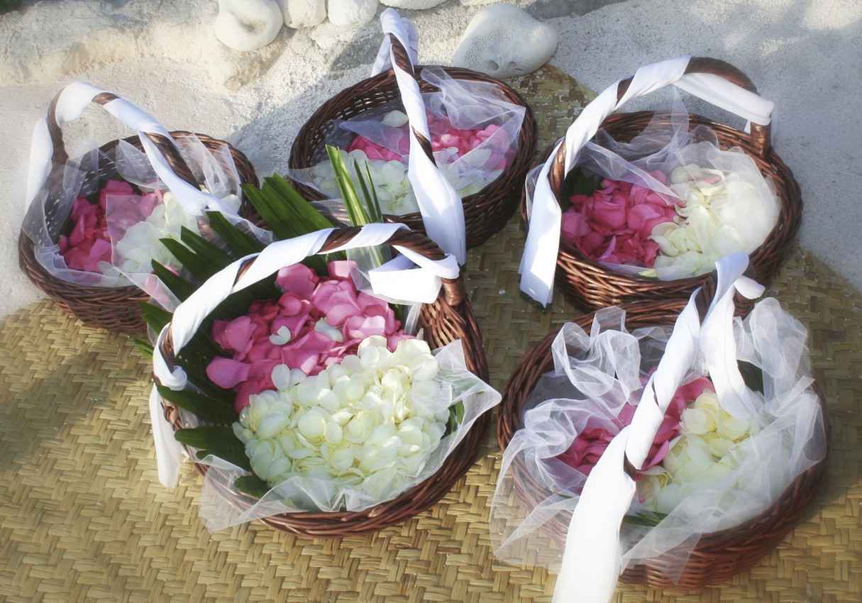 Several flower petal baskets ready for a beach wedding.