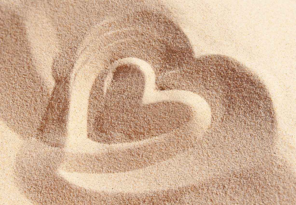 A large heart drawn in the sand.