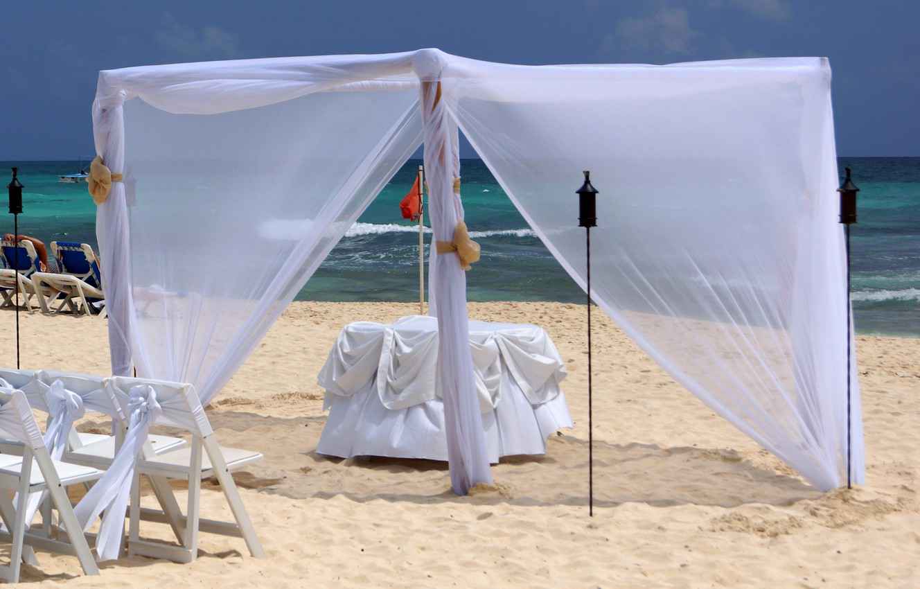 The preliminary preparations for a beach wedding ceremony.