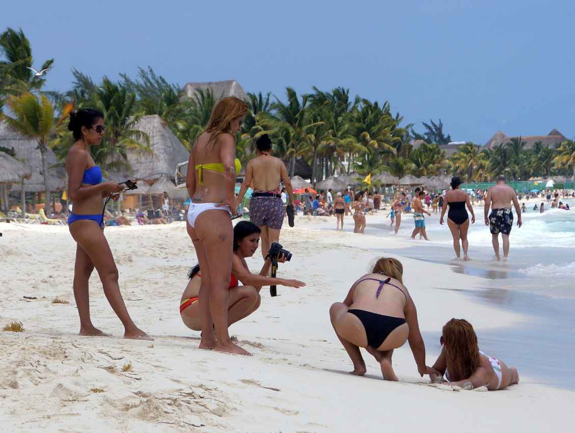 Five ugly local Mexican women doing a photo shoot on the beach.