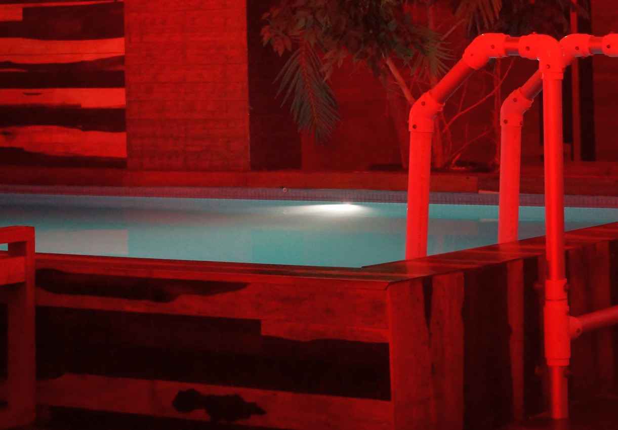 A small swimming pool in the red room at a Playa Del Carmen club.