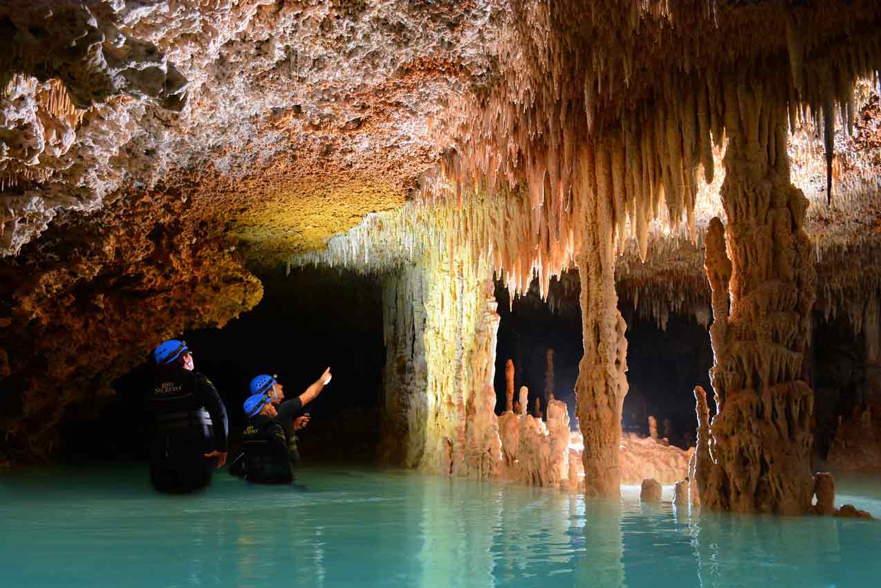 guide-at-rio-secreto-tulum-explaining-how-stalactites-and-stalagmites-were-fromed