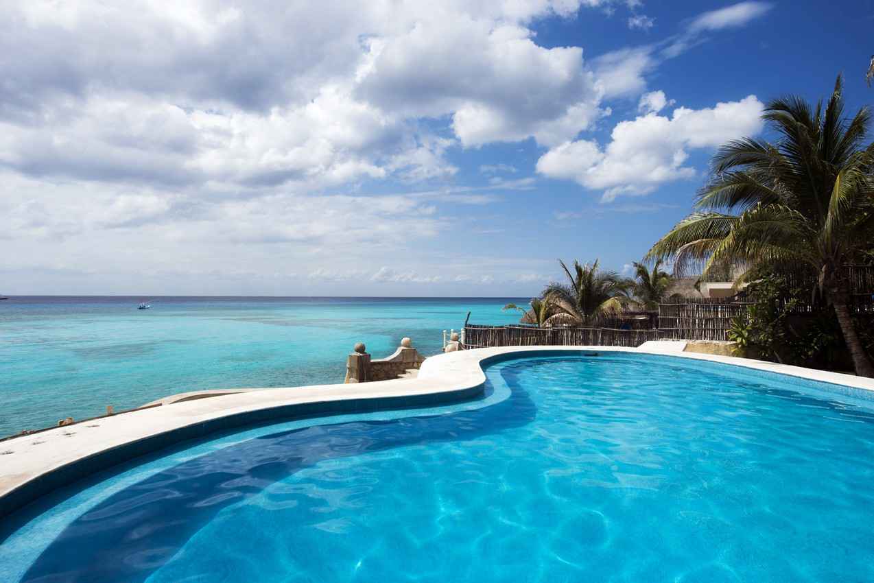 A swimming pool overlooking the beach at a Playa Del Carmen villa.