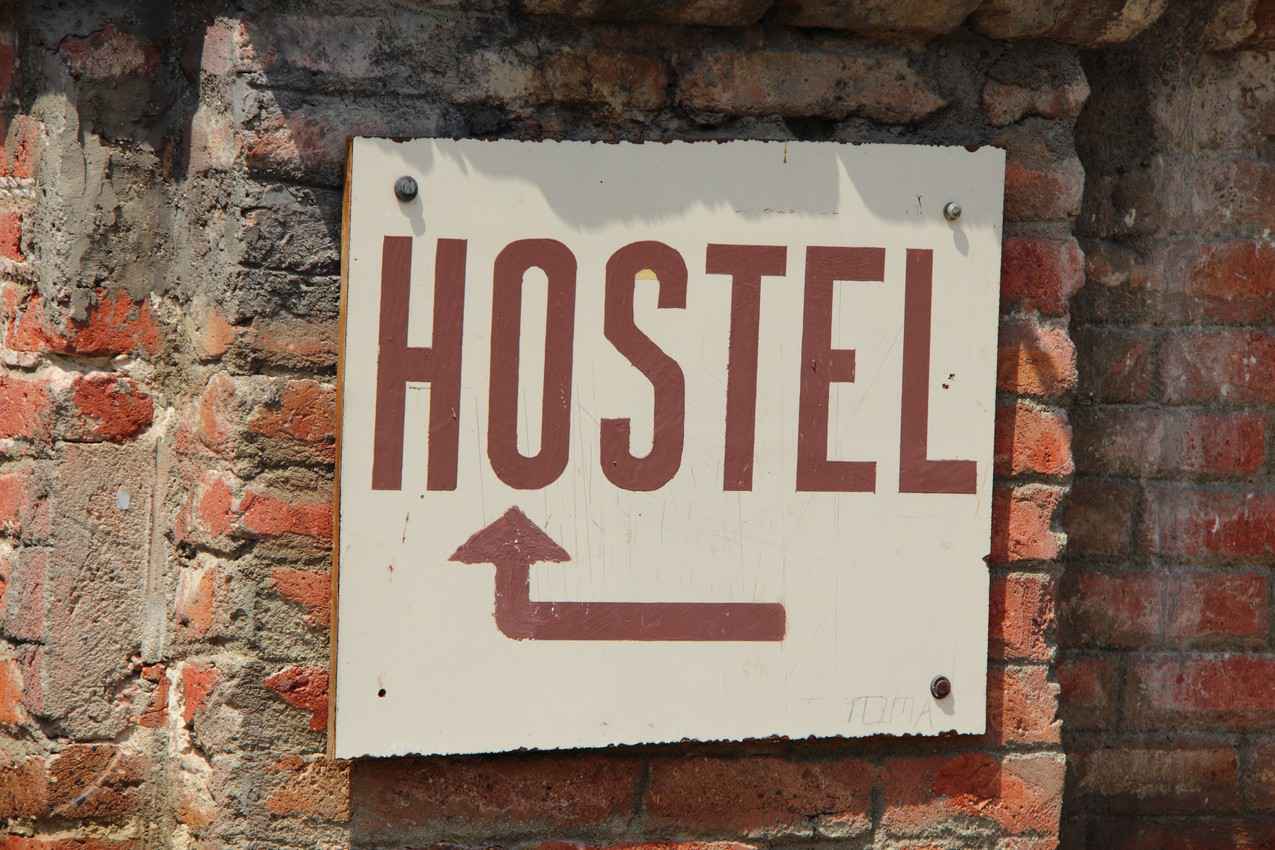 A hostel sign on a brick wall in Playa Del Carmen.