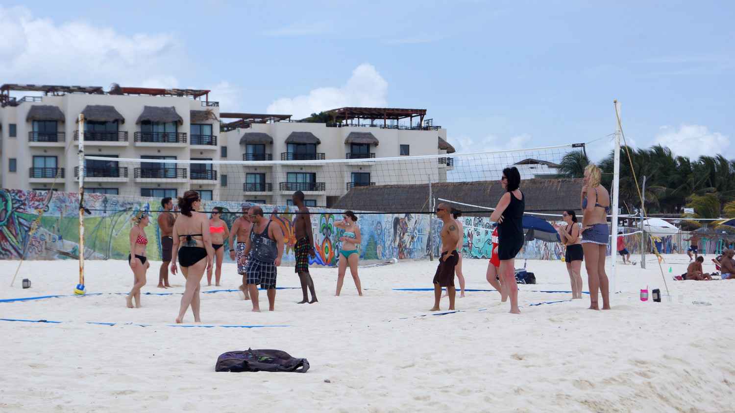 Several people playing beach volleyball in Playa Del Carmen.