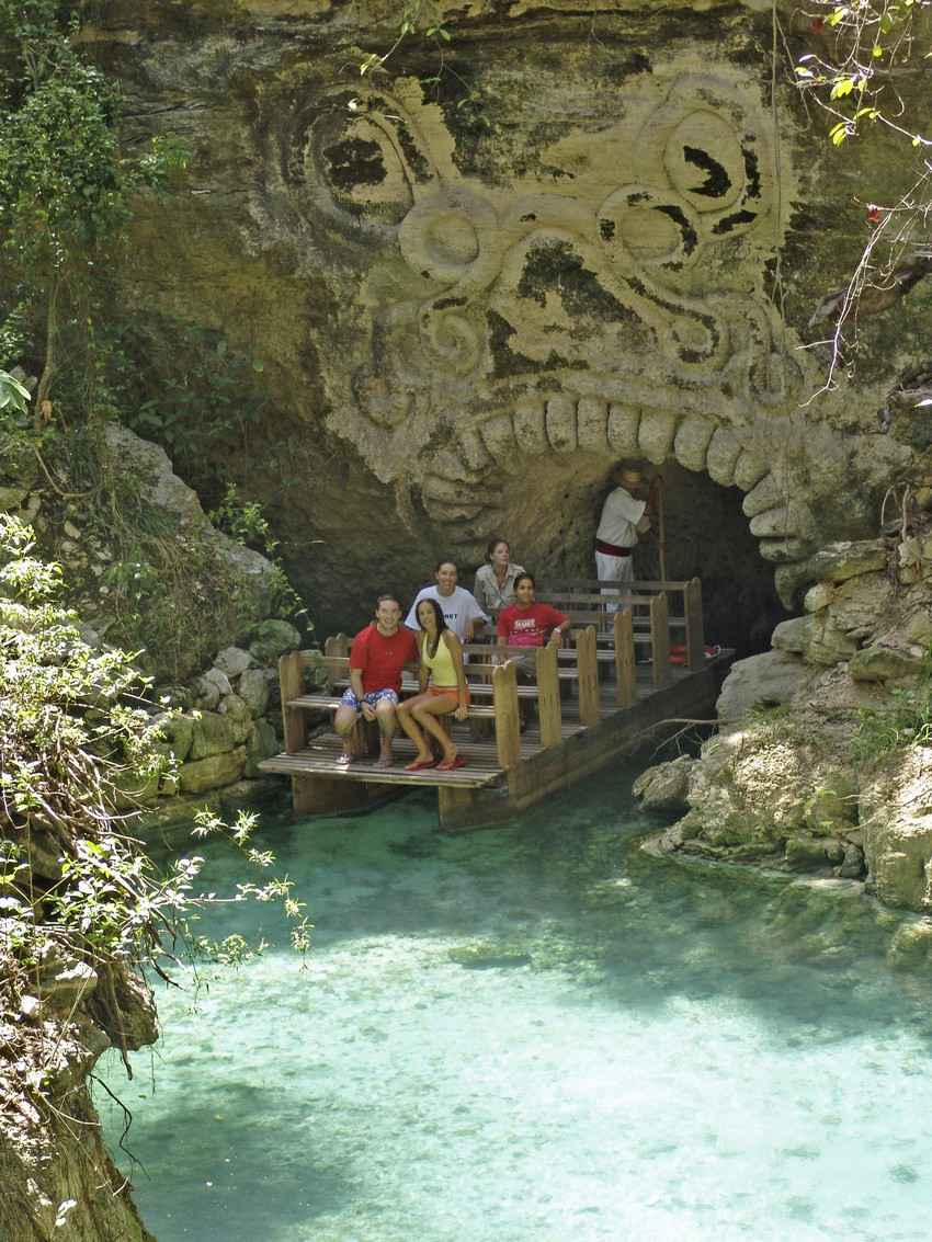 A group of people riding a riverboat in the Riviera Maya.