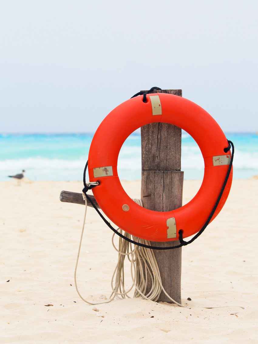 A lifesaver on the beach near the sea.