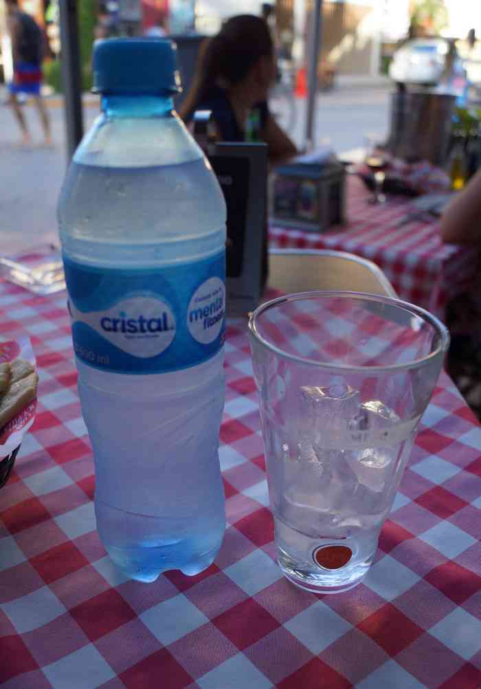 A bottle of water on the table on Fifth Avenue.