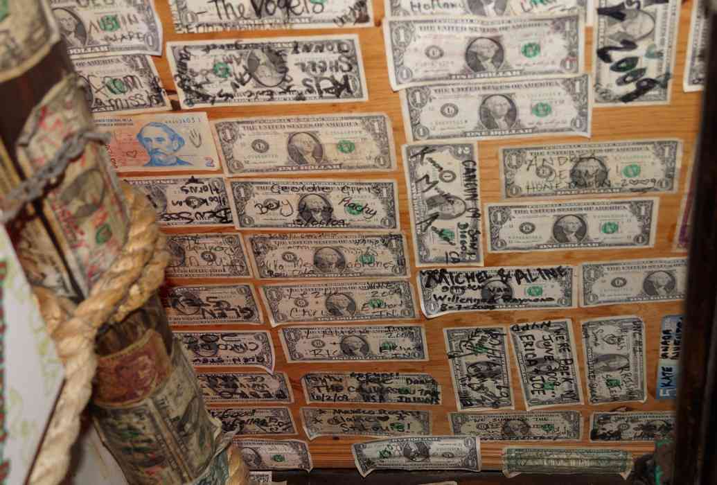 Dollar bills hanging above the Pez Vela bar.