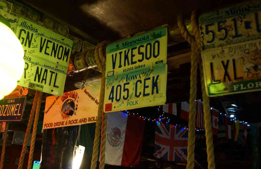 A number of license plates hanging above the Pez-Vela bar pn Fifth Avenue.