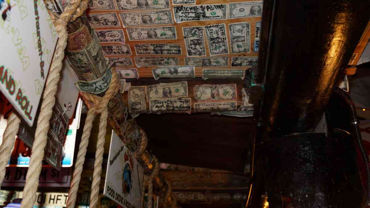 Morer dollar bills hanging above a bar in Playa Del Carmen.