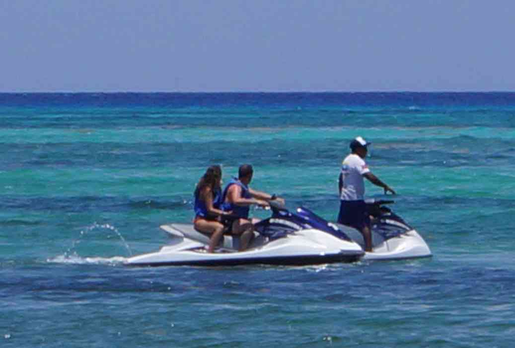 Several people on wave runners near the beach in Playa Del Carmen.