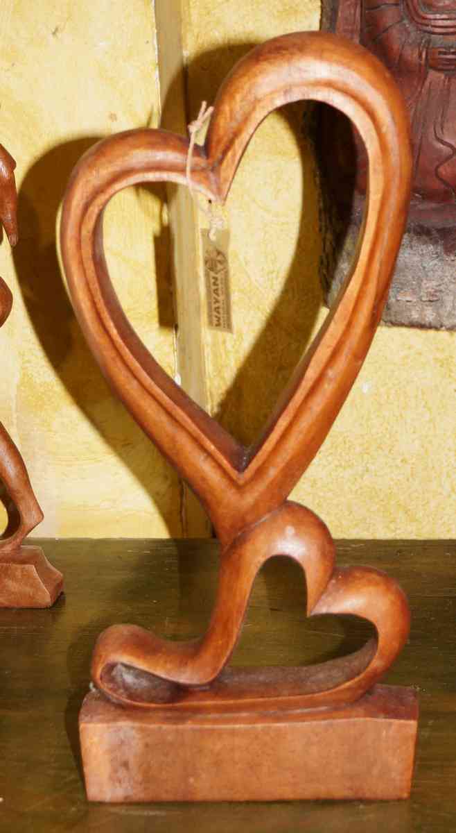A sculpture of a wooden heart for sale in Playa Del Carmen.