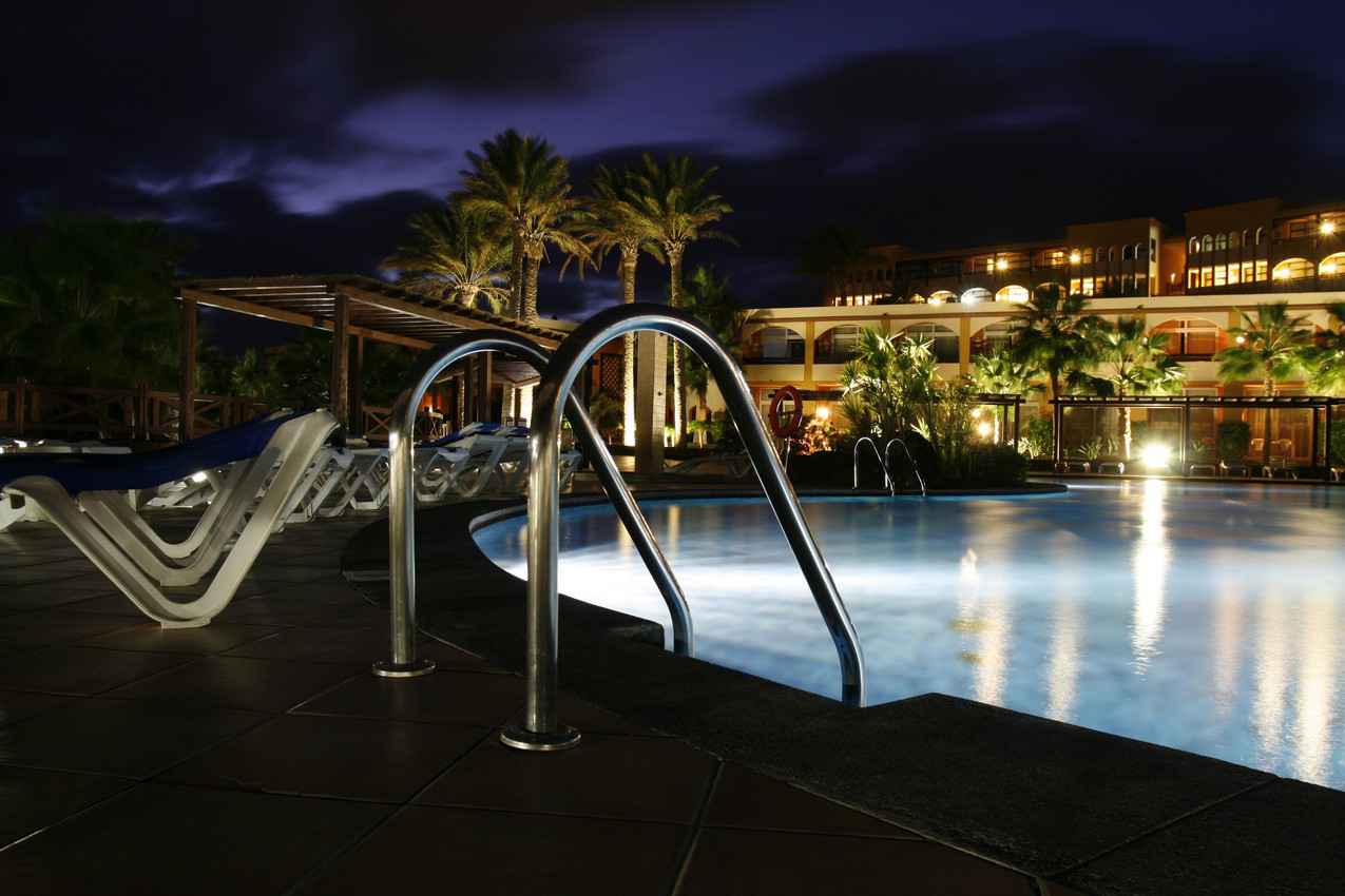 A resort swimming pool as seen at night.