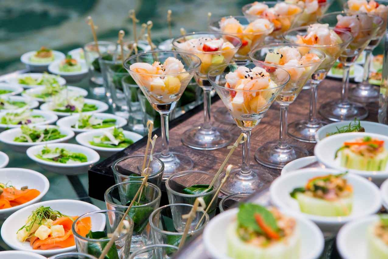Several seafood cocktails and small salads waiting to be served to resort guests.