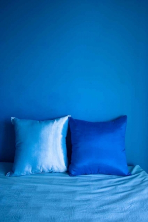 Several decorative pillows on a bed.