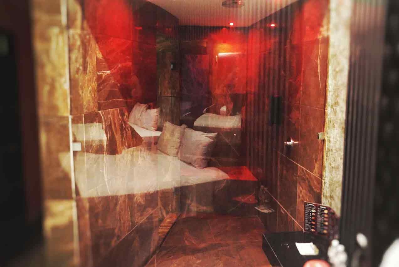An amazing shower with sexy red lights inside of a honeymoon suite in Playa Del Carmen.