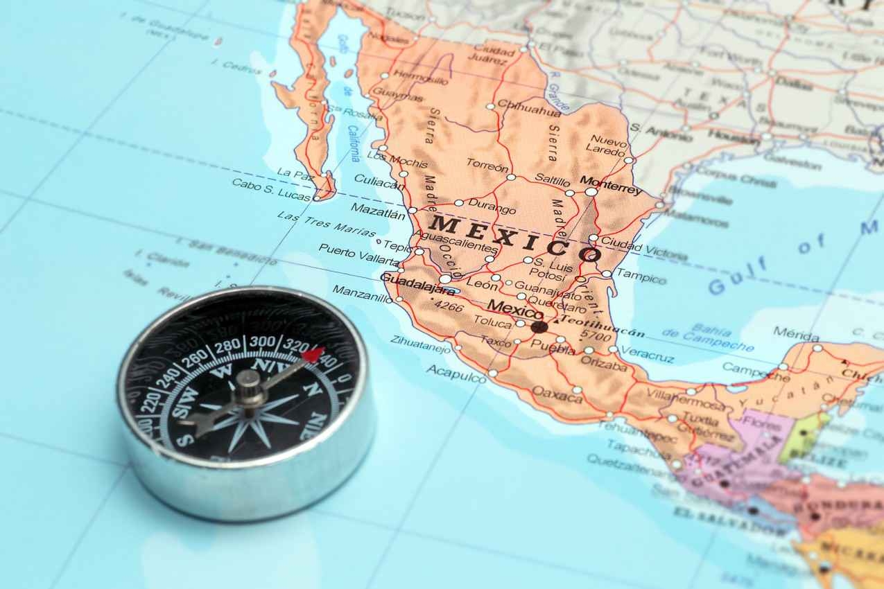 A Mexican map with a compass on top of it.