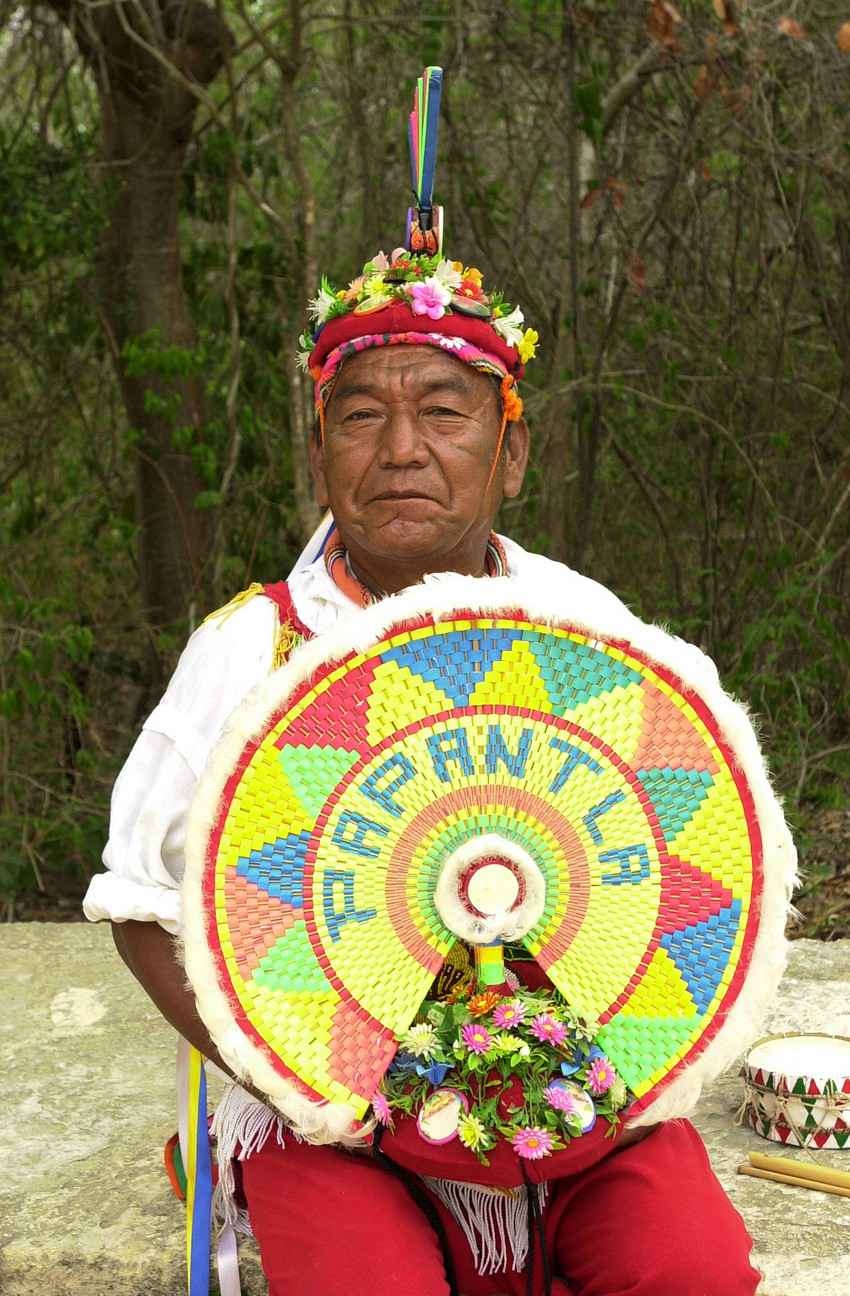 An elderly Mayan man in full regalia.