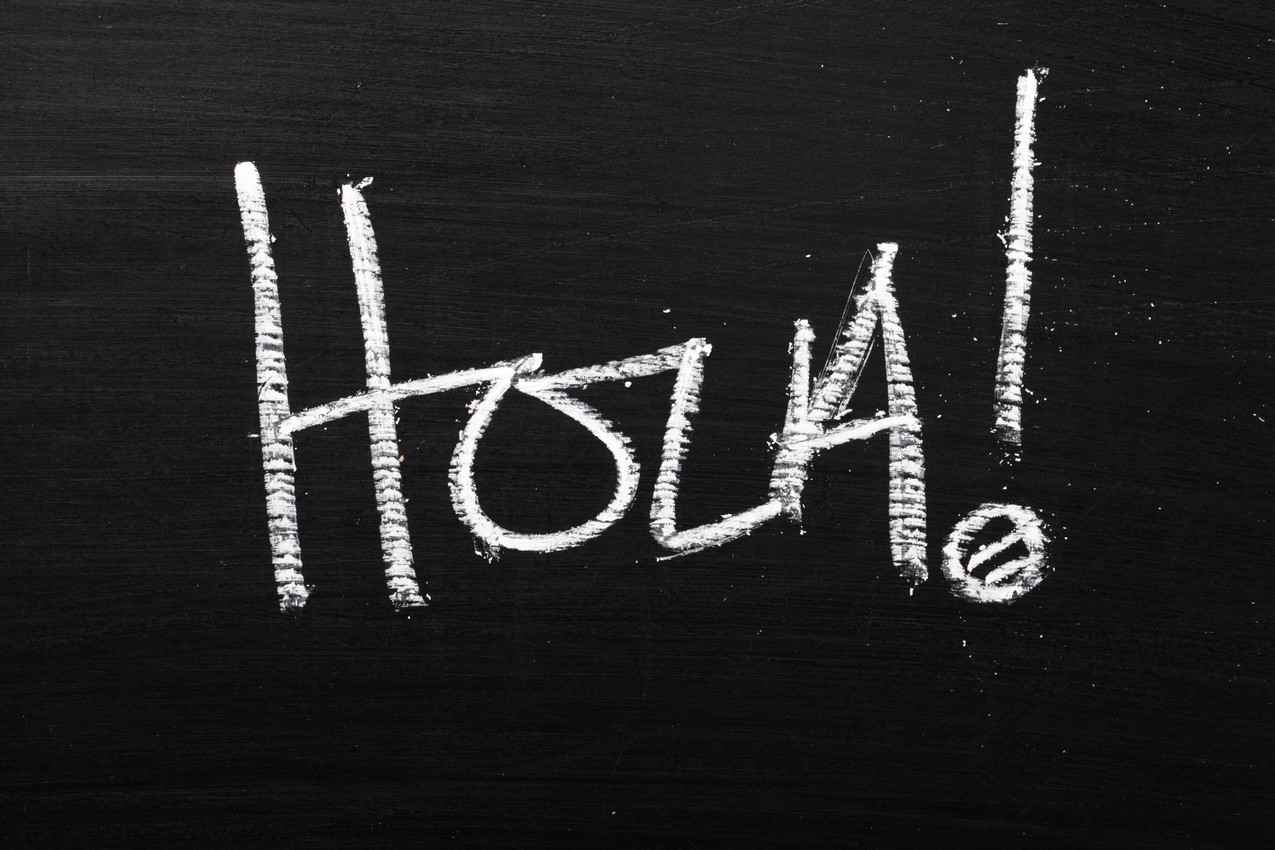 hola written on chalkboard