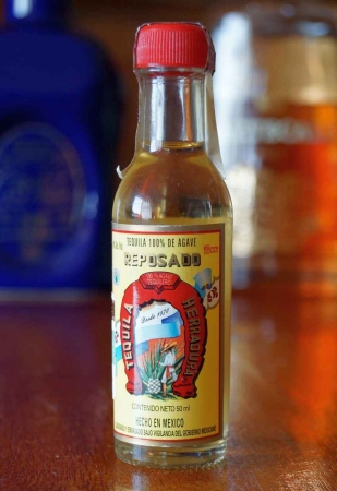 A miniature bottle of Reposado tequila.