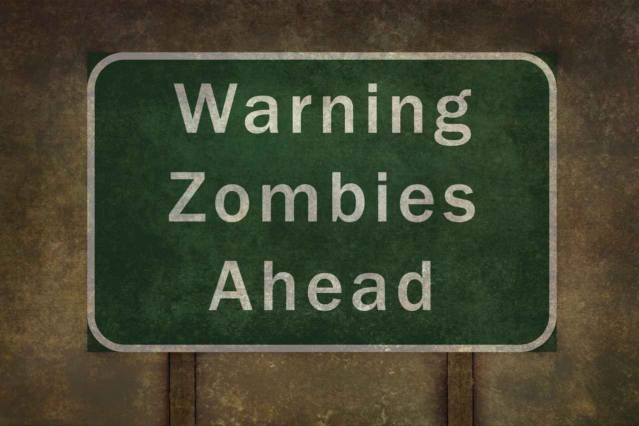 A street sign that reads, warning zombies ahead.