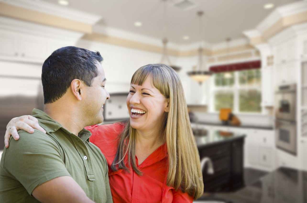 A man and a woman who appear to be extremely happy with their new property.