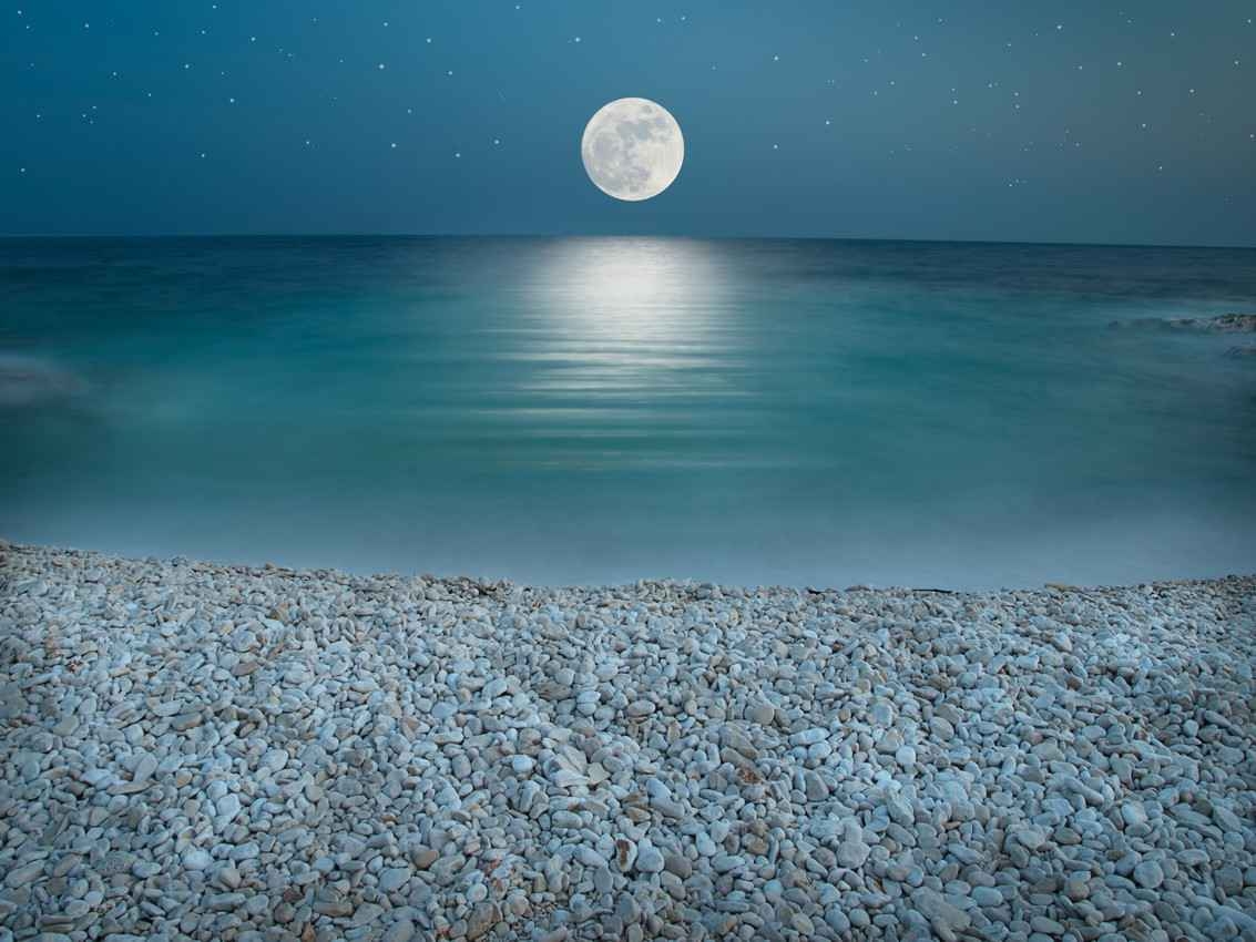 A full moon shining over the Caribbean Sea.