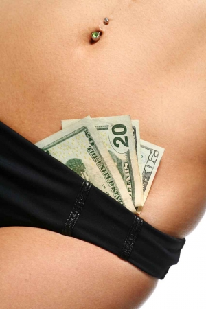 An exotic dancer with money in her bikini bottom.