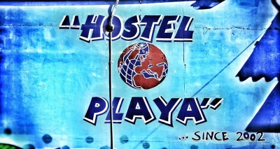 A painted logo on the wall of Hostel Playa