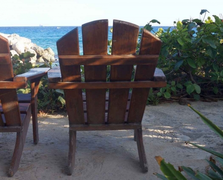 A wooden chair at a hotel near the beach.