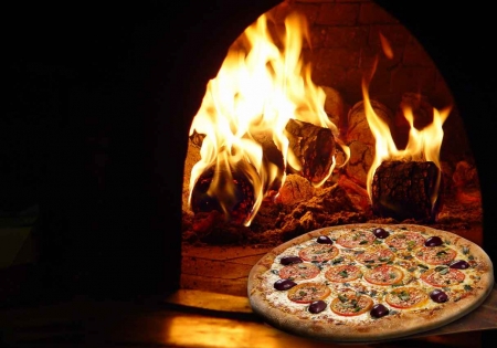 An Italian pizza cooked at a restaurant in an authentic brick oven.