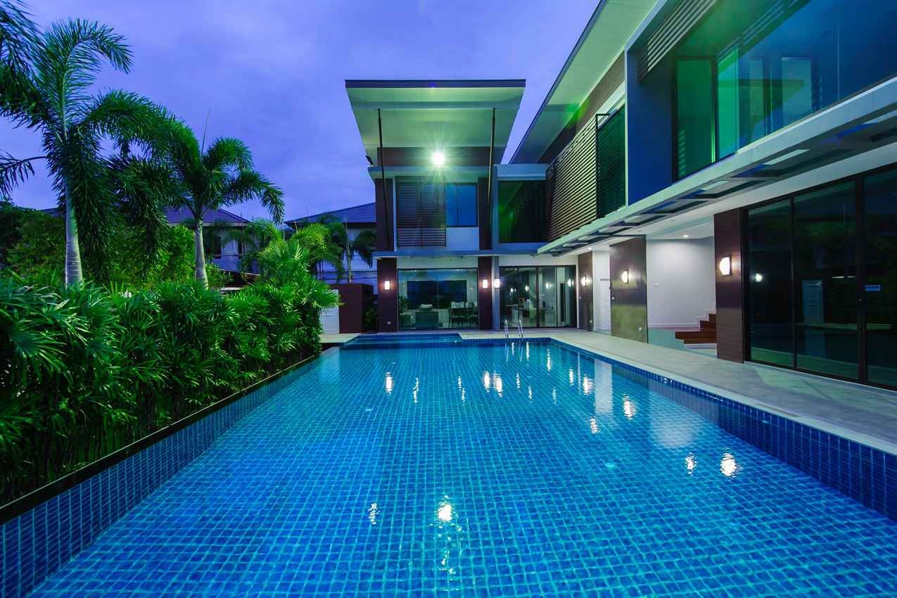 A large and expensive rental home with a shallow swimming pool.