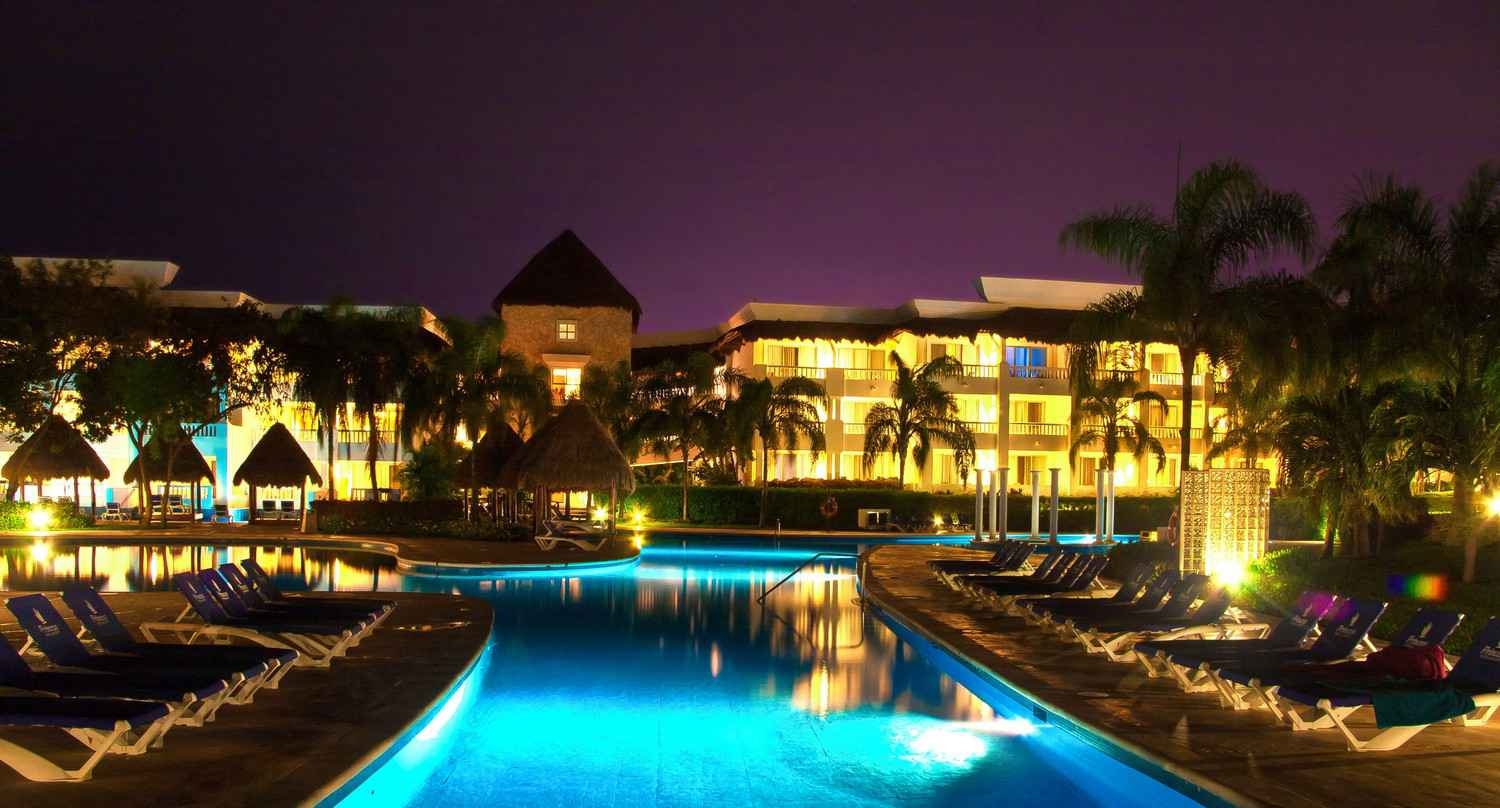 A large resort at night with many lights.